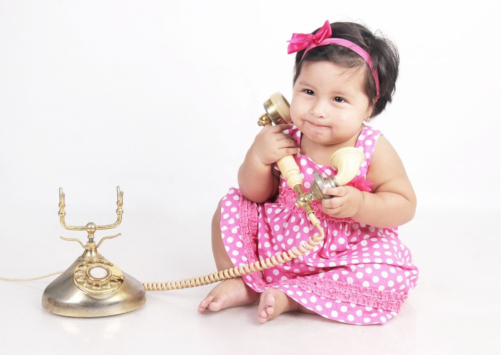 une petite fille avec son téléphone vintage